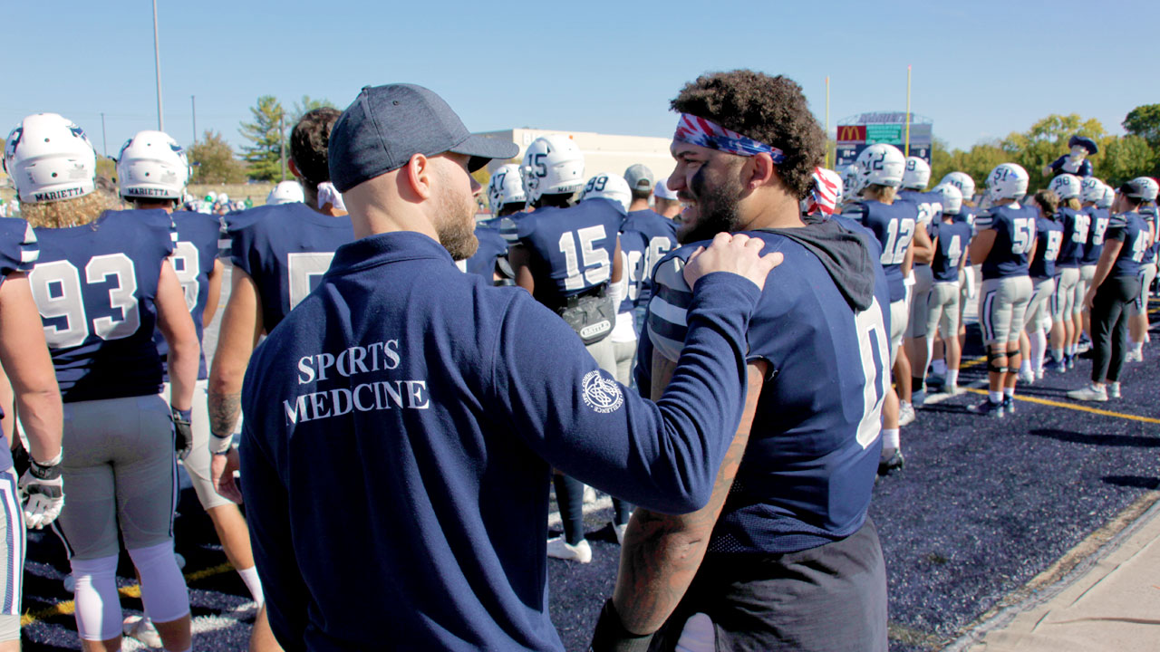 doctor talking to player on field